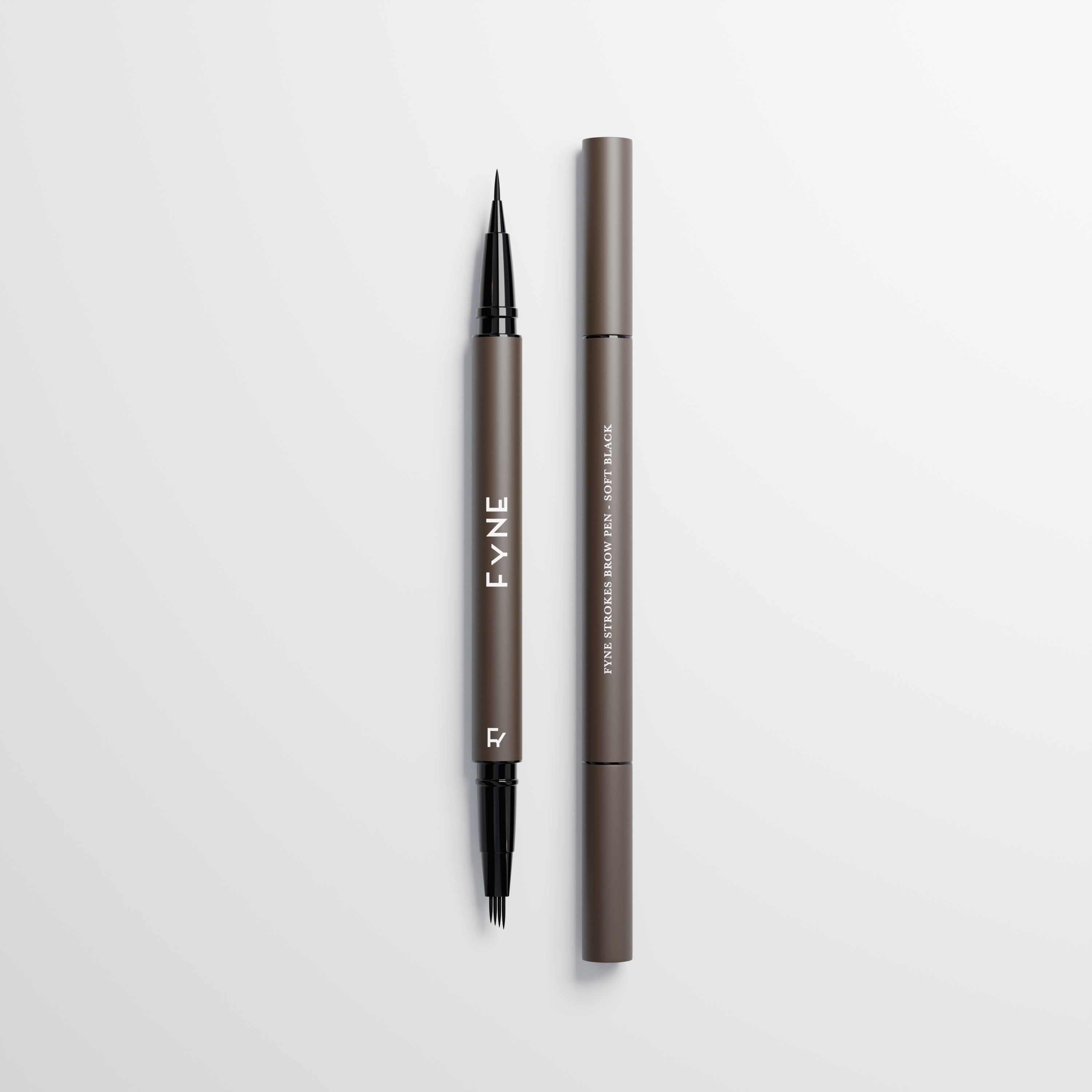 Eyebrow stroke pen in soft black used for microblading eyebrow strokes on a light grey background