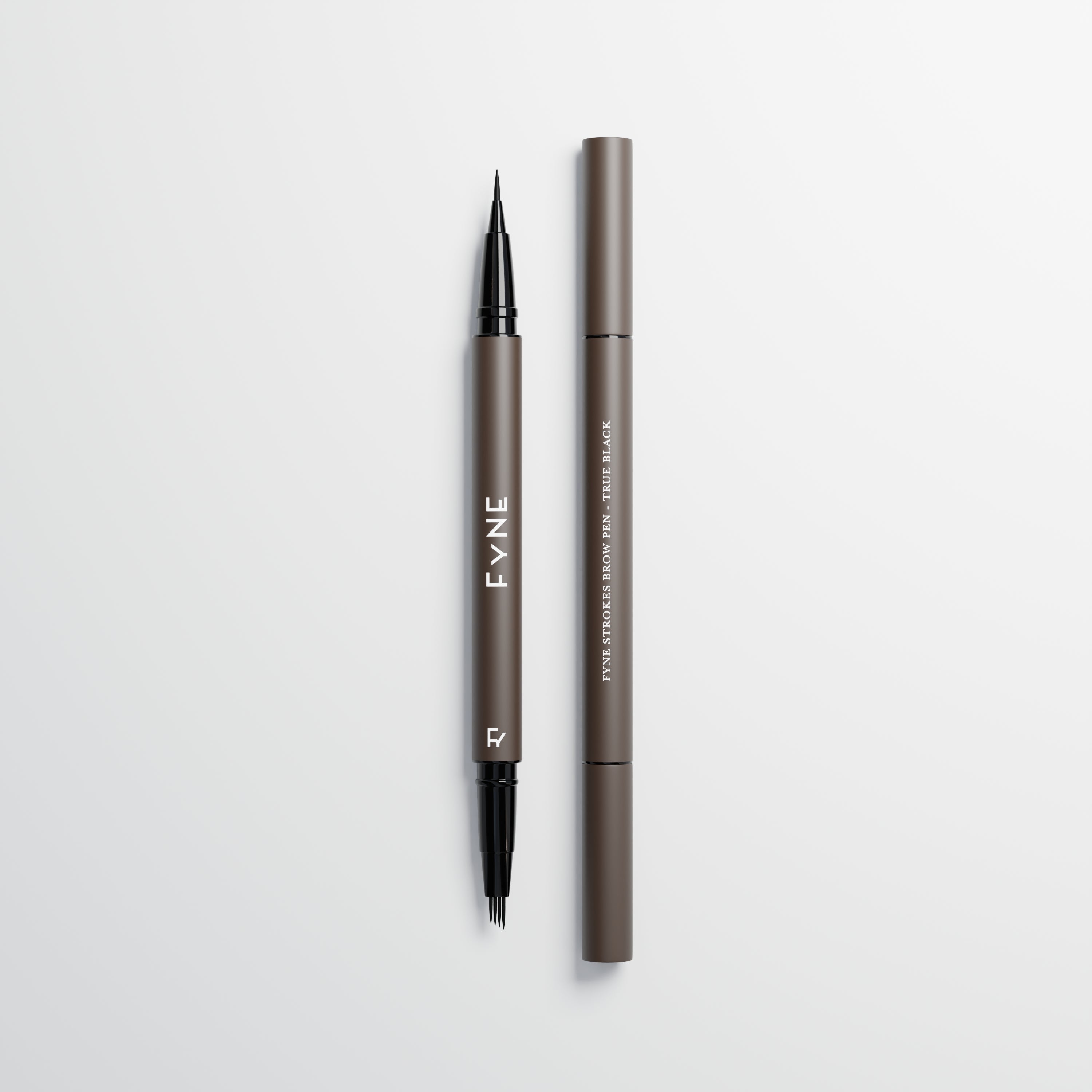 Eyebrow stroke pen in true black used for microblading eyebrow strokes on a light grey background